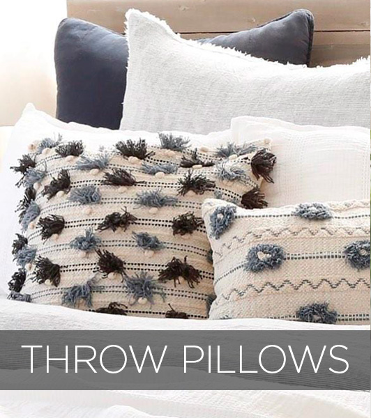 Throw pillows on a bed with text that reads throw pillows.