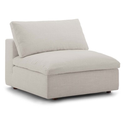 A white couch with a cushion on it.