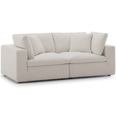 A sectional sofa with pillows on a white background.