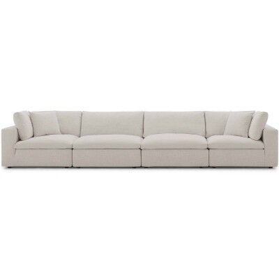 A white sectional sofa with cushions on it.