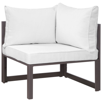An outdoor corner chair with white cushions.