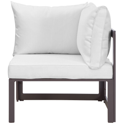 A white outdoor corner chair with a white cushion.