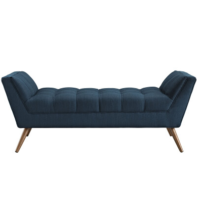 A blue upholstered bench with wooden legs.