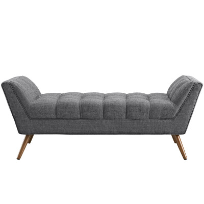 A grey upholstered bench with wooden legs.