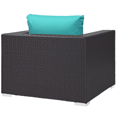 A wicker lounge chair with a turquoise cushion.