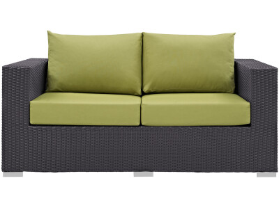A black wicker loveseat with lime cushions.