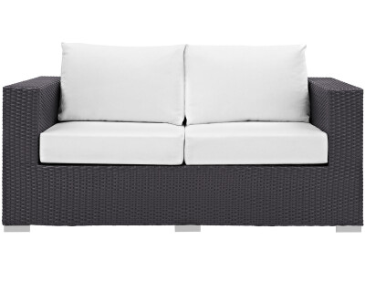 A black and white wicker loveseat on a white background.