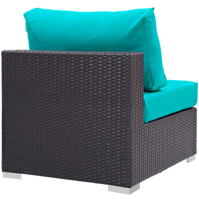 An outdoor wicker chair with turquoise cushions.