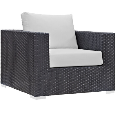 A black wicker lounge chair with white cushion.