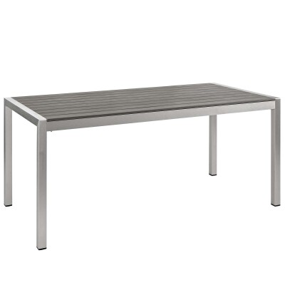 An outdoor dining table with a grey top and silver legs.