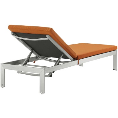 A chaise lounge with orange cushion on a white background.