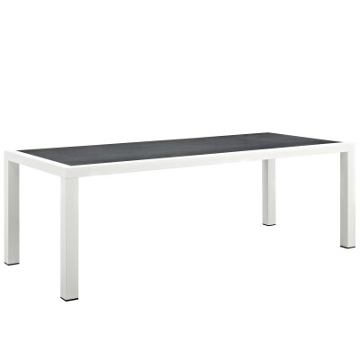 A white dining table with a black top.