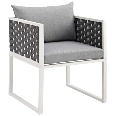 An outdoor wicker chair with grey cushion and white frame.