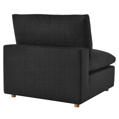 A black upholstered chair with wooden legs.