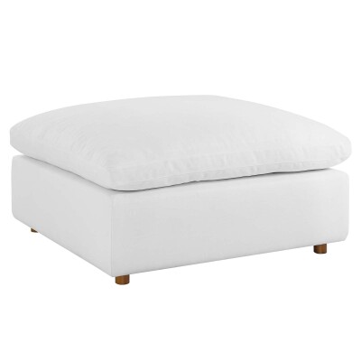 A white ottoman with wooden legs on a white background.