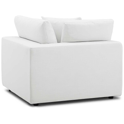A white couch with pillows on it.