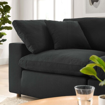 A black sectional sofa in a living room.