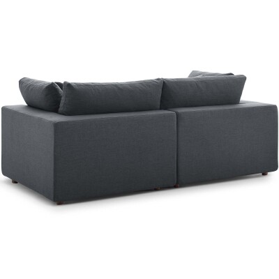 An image of a grey couch with pillows on it.