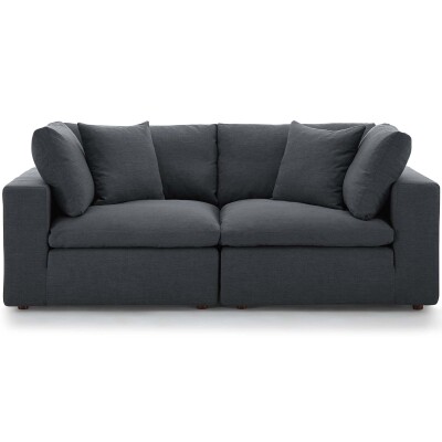 A gray couch with pillows on it.