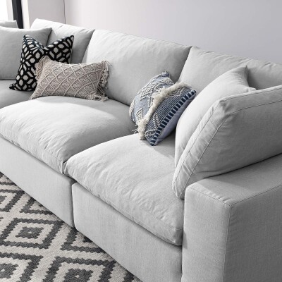 A sectional sofa with pillows in a living room.