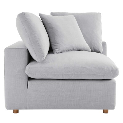 A grey couch with pillows on it.