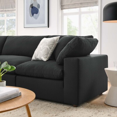 A black sectional sofa in a living room.