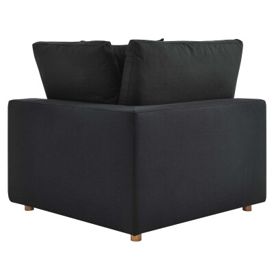 A black sofa with two pillows on top.