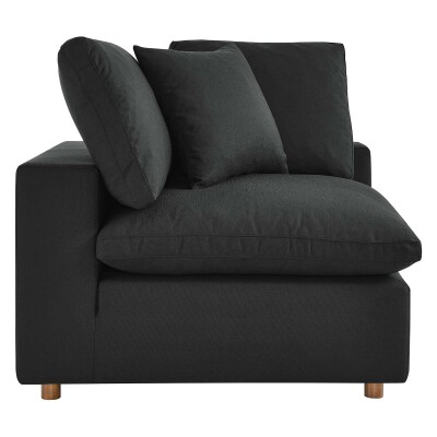 A black couch with two pillows on it.