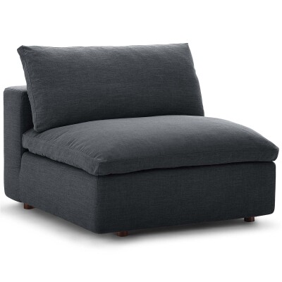 A grey couch with a cushion on it.