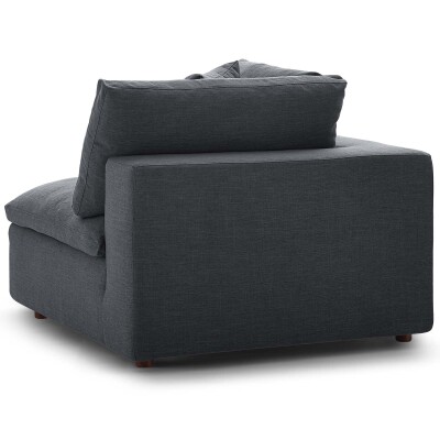 A gray couch with a pillow on it.
