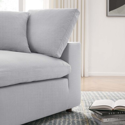 A grey couch with pillows in a living room.
