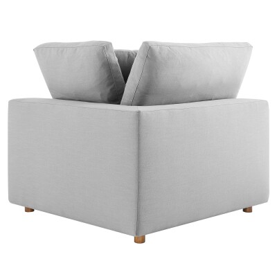 A grey couch with two pillows on top.