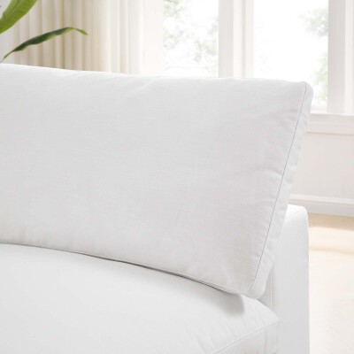 A white couch with a white pillow on it.