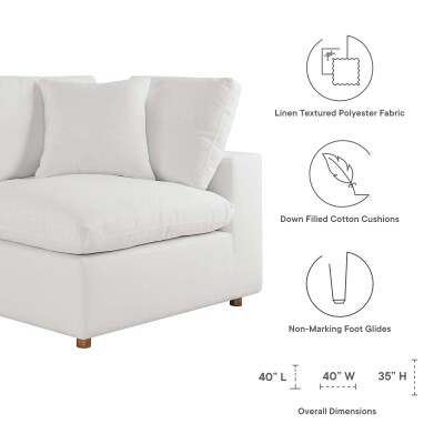 A white sectional sofa with a white cushion.