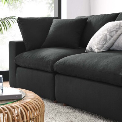 A black couch in a living room.