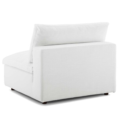 A white couch with a back and armrest.