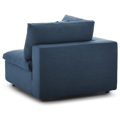 A blue couch with a pillow on it.