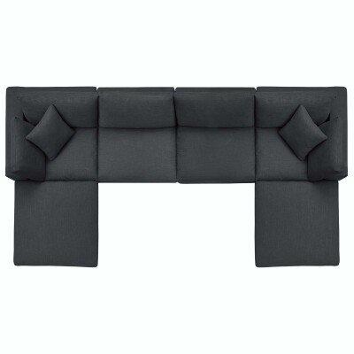 A black sectional sofa with two pillows.