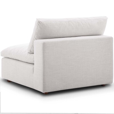 A white couch with a white cushion on it.