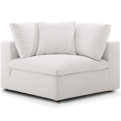 A white corner chair with pillows on a white background.
