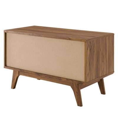 A modern sideboard with wooden legs and a tan cover.