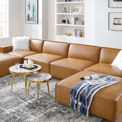 A tan leather sectional sofa in a living room.