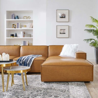 A tan leather sectional sofa in a living room.