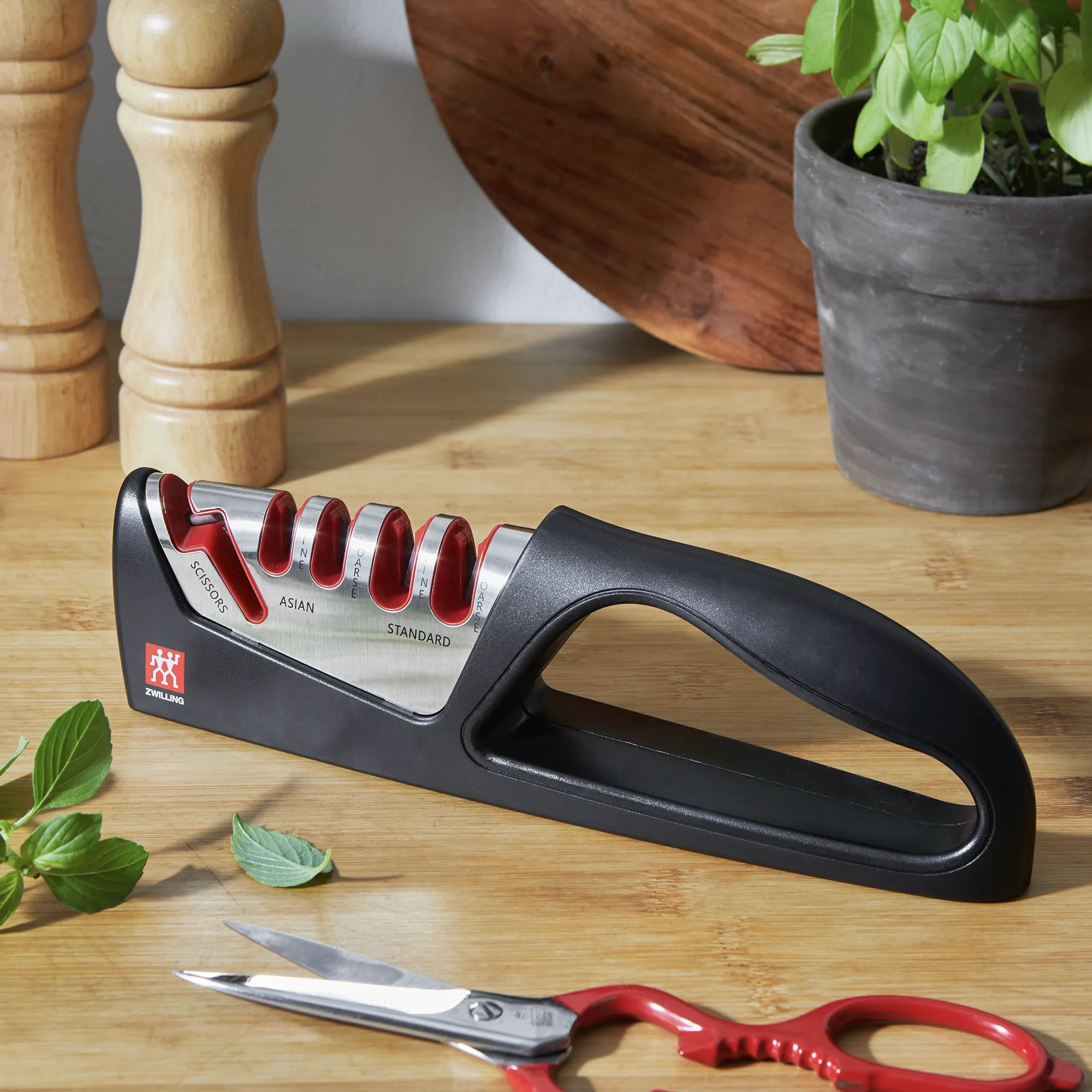 https://www.homethreads.com/files/zwilling/1010831-zwilling-razor-sharp-4-stage-pull-through-knife-sharpener-with-shear-sharpener-german-engineered-informed-by-100-years-of-mastery-3.webp