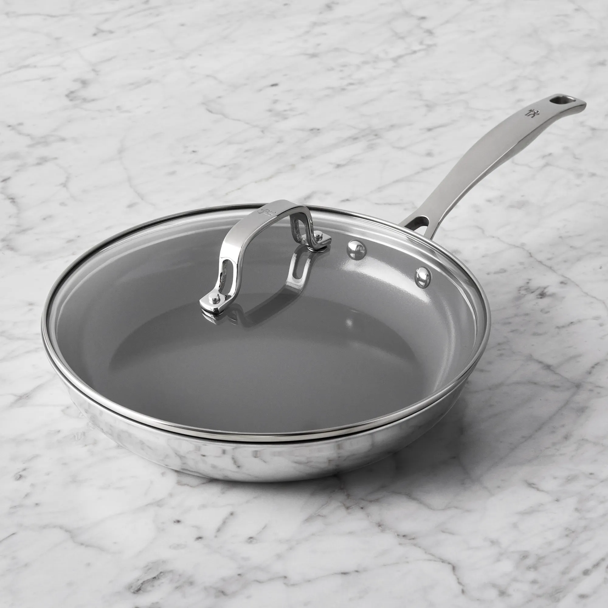 https://www.homethreads.com/files/zwilling/1023638-henckels-clad-h3-10-inch-stainless-steel-ceramic-nonstick-fry-pan-with-lid-5.webp