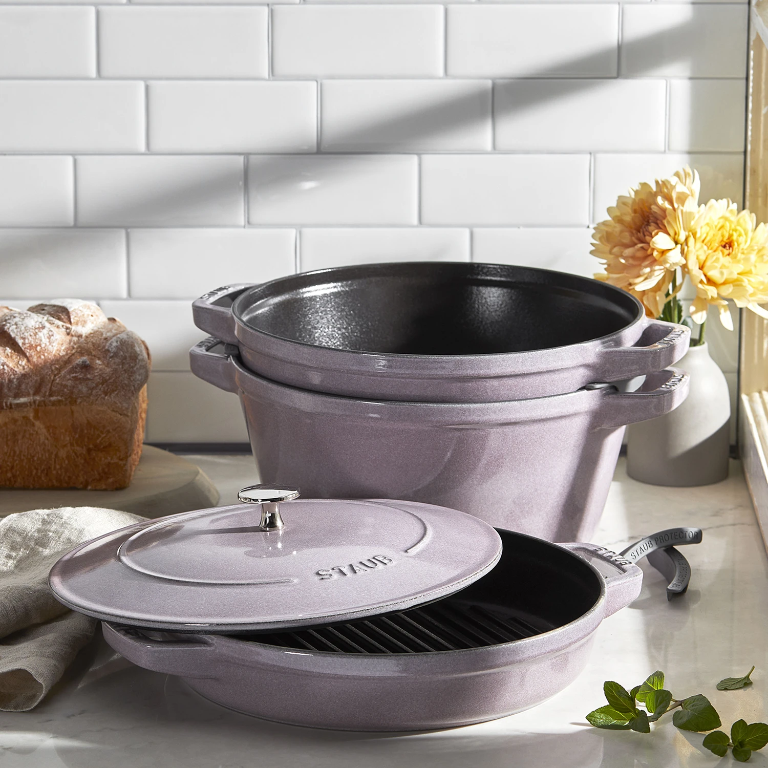https://www.homethreads.com/files/zwilling/145526117-staub-cast-iron-set-4-pc-stackable-space-saving-cookware-set-dutch-oven-with-universal-lid-made-in-france-lilac-16.webp